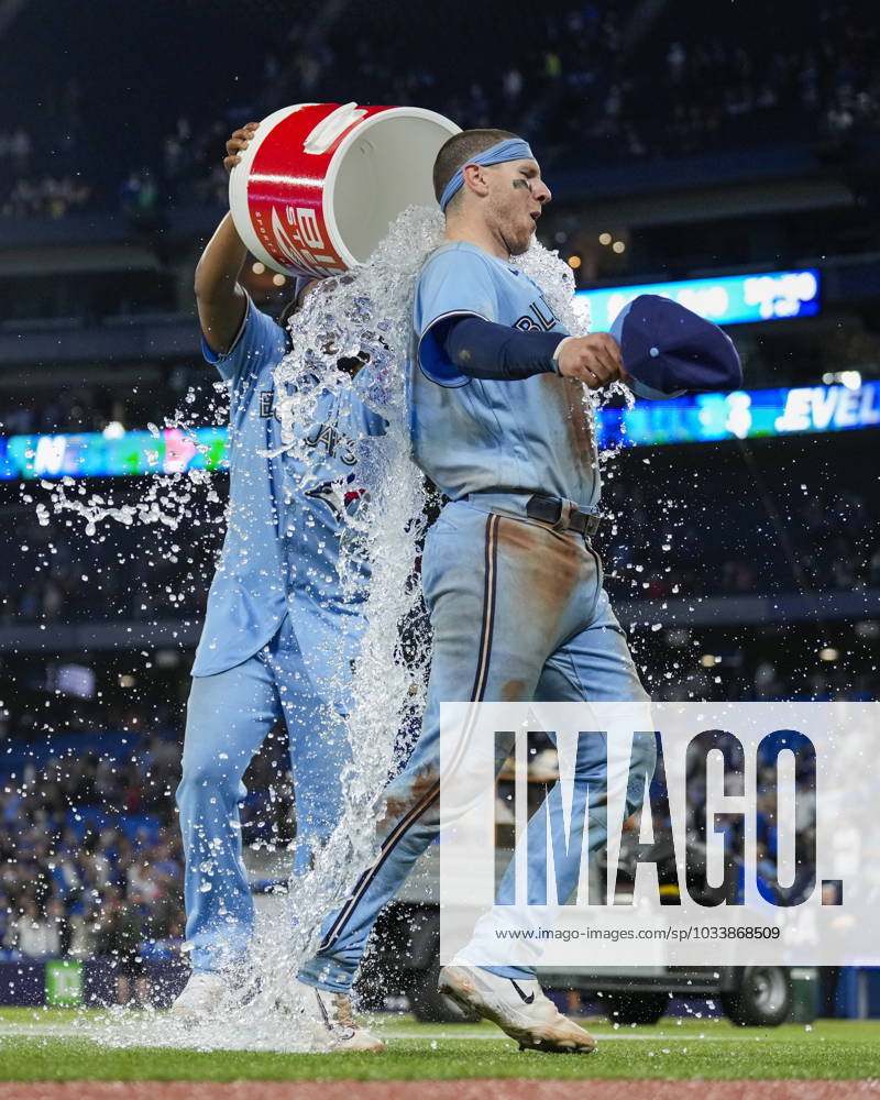 Toronto Blue Jays catcher Danny Jansen (9) is doused by teammate first baseman Vladimir Guerrero Jr. (27) after defeating the Washington Nationals in MLB, Baseball Herren, USA interleague baseball action in Toronto on Monday, August 28, 2023. Canada News - August 28, 2023 - ZUMAc35_ 20230828_zaf_c35_059