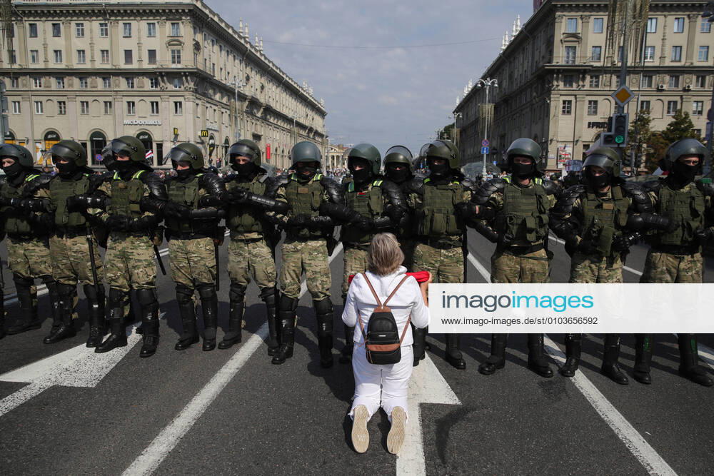 A Belarusian opposition supporter kneels in front of riot police officers during a protest in Independence Avenue. The announcement of the results of the 2020 Belarusian presidential election has sparked mass protests in Minsk and major cities across Belarus. Sergei Bobylev TASS TS0E5306