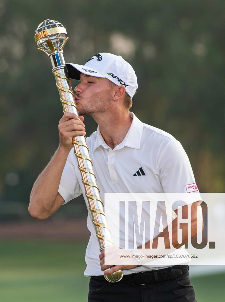 NICOLAI HoJGAARD of Denmark kisses the trophy after winning DP World Tour Championship in Dubai, United Arab Emirates, Nov 19, 2023. Dubai United Arab Emirates