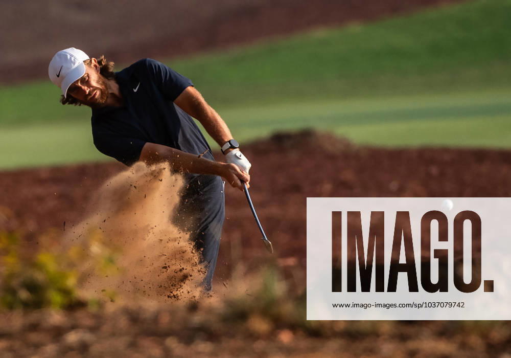 TOMMY FLEETWOOD of England strikes the ball from the rough on the 18th fairway during DP World Tour Championship in Dubai, United Arab Emirates, Nov 19, 2023. Dubai United Arab Emirates