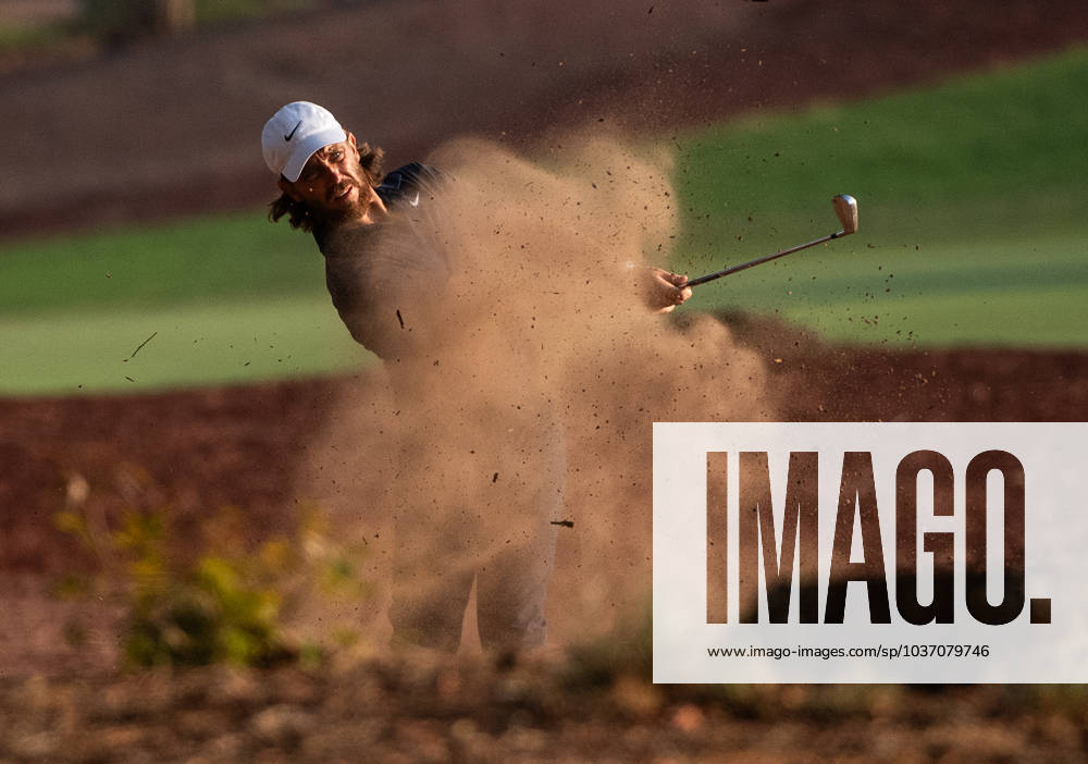 TOMMY FLEETWOOD of England strikes the ball from the rough on the 18th fairway during DP World Tour Championship in Dubai, United Arab Emirates, Nov 19, 2023. Dubai United Arab Emirates