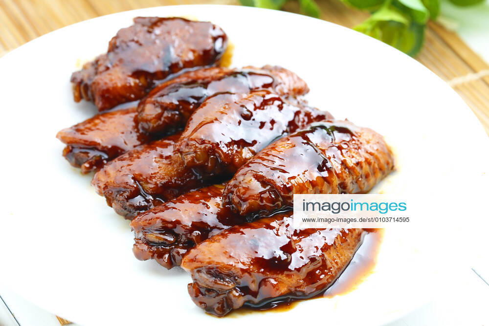 Coke chicken wings on a white plate. 684073640457142291