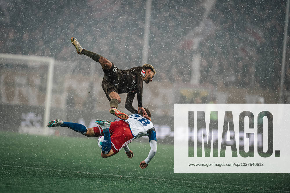 Soccer Men Season 2023 2024 2 Football Bundesliga 15 Matchday FC St Pauli vs Hamburger SV 01 12 2023 Tough duel between Elias Saad 26, top, FC St Pauli and Miro Muheim 28, bottom, HSV both in the air in the snow Hamburg Millerntor Stadion Hamburg Germany