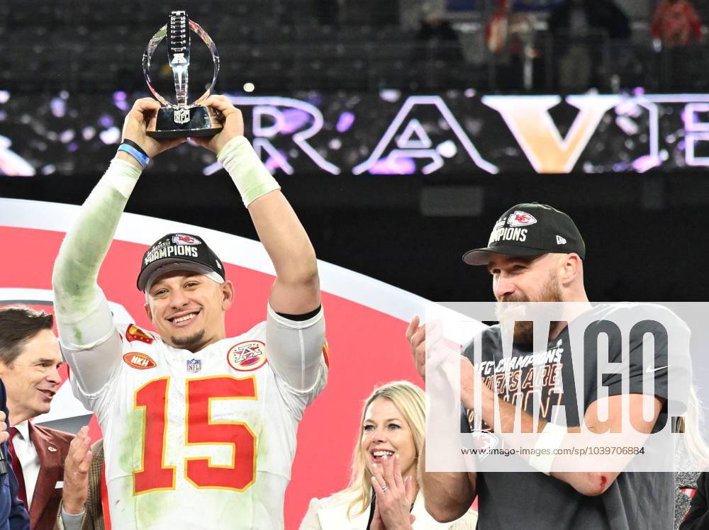 KW04 Kansas City Chiefs quarterback Patrick Mahomes raises the Lamar Hunt trophy as tight end Travis Kelce (R) applauds after the Chiefs defeated the Baltimore Ravens 17-10 to win the 2024 AFC Championship game at M&T Bank Stadium in Baltimore, Maryland on Sunday, January 28, 2024. The Chiefs go on to play the NFC Champions in Super Bowl LVIII on February 11. BAL20240128683 DAVIDxTULIS