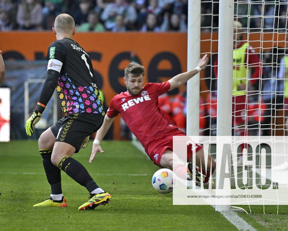 Soccer 1 Bundesliga 2023 2024, Matchday 27, FC Augsburg 1 FC Köln, in the WWK Arena Augsburg, Jan Thielmann Köln scrapes the ball away from the line f l Goalkeeper Marvin Schwäbe Köln and Jan Thielmann Köln DFL and DFB regulations prohibit any use of photographs as image sequences and or quasi video