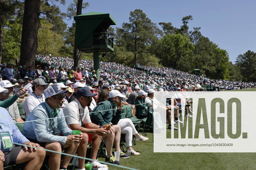Patrons wait for golfers at Amen Corner near the eleventh hole in the second round of the Masters Tournament at Augusta National Golf Club in Augusta, Georgia on Friday, April 12, 2024. AUG20240412521 TANNENxMAURY