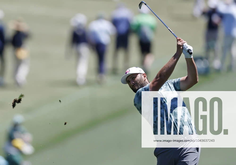 Spain s Jon Rahm hits his approach shot on the first hole in the second round of the Masters Tournament at Augusta National Golf Club in Augusta, Georgia on Friday, April 12, 2024. AUG20240412115 JOHNxANGELILLO