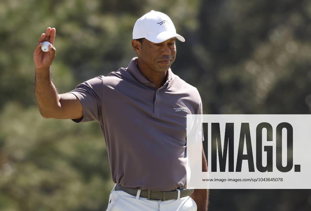 Tiger Woods waves after sinking a putt on the eighteenth green during the second round of the Masters Tournament at Augusta National Golf Club in Augusta, Georgia on Friday, April 12, 2024. Woods finished the day at one-over-par. AUG20240412131 JOHNxANGELILLO