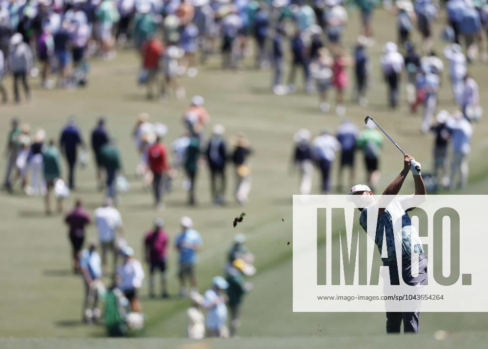 John Rahm of Spain hits his approach shot on the first hole during the second round of the Masters Tournament at Augusta National Golf Club in Augusta, Georgia on Friday, April 12, 2024. AUG202404121003 JOHNxANGELILLO