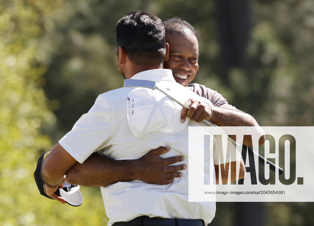 Tiger Woods hugs Jason Day on the eighteenth green in the second round of the Masters Tournament at Augusta National Golf Club in Augusta, Georgia on Friday, April 12, 2024. Tiger Woods set a Masters record with his 24th straight made cut at Augusta National. AUG202404121009 JOHNxANGELILLO