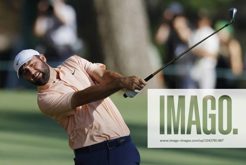 Scottie Scheffler hits an approach shot on the fifteenth hole on the final day of the Masters Tournament at Augusta National Golf Club in Augusta, Georgia on Sunday, April 14, 2024. AUG20240414138 JOHNxANGELILLO