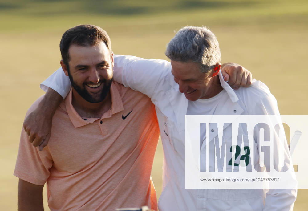 Scottie Scheffler celebrates with caddie Ted Scott after winning the Masters tournament at Augusta National Golf Club in Augusta, Georgia on Sunday, April 14, 2024. Scheffler won with a score of 11 under par. AUG20240414546 TANNENxMAURY