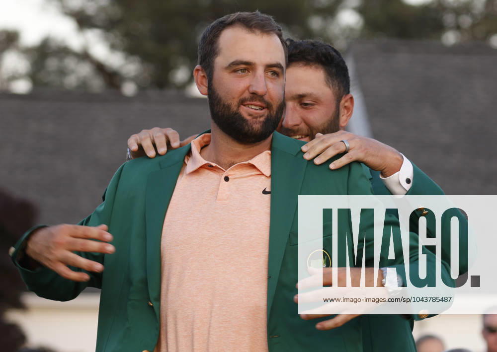 Masters winner Scottie Scheffler receives his Green Jacket from last years winner Jon Rahm after the final round of the Masters tournament at Augusta National Golf Club in Augusta, Georgia on Sunday, April 14, 2024. Scheffler won with a score of 11 under par. AUG20240414577 TANNENxMAURY