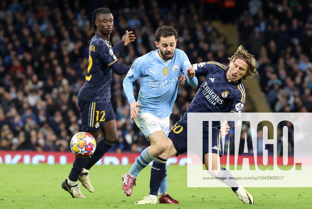 17th April 2024; Etihad Stadium, Manchester, England; Champions League Football, Quarter Final, Manchester City versus Real Madrid; Luka Modric of Real Madrid brings down Bernardo Silva of Manchester City ActionPlus12631648 DavidxBlunsden Content restricted for UK based newspaper