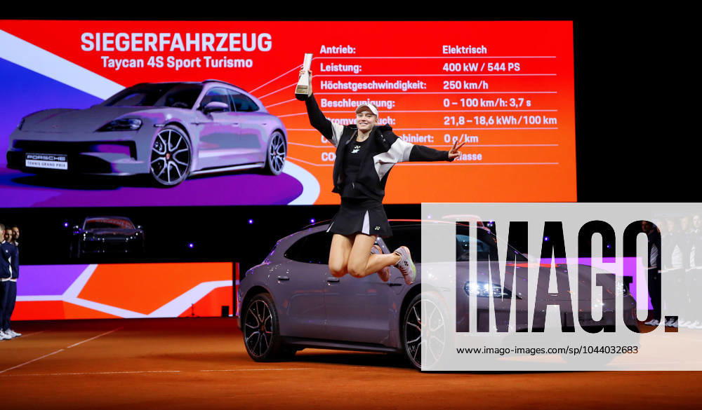 Germany, Stuttgart, Porsche Tennis Grand Prix 2024, Final, Elena Rybakina KAZ jumps into the air with the trophy in front of her winning car Taycab 4S Sport Turismo
