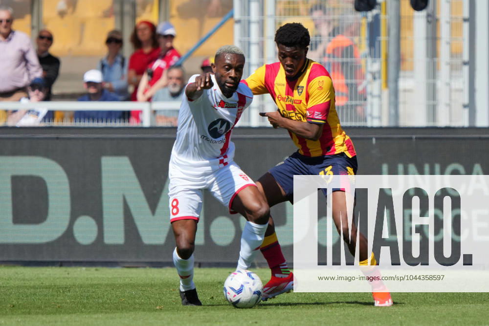 Jean-Daniel Akpa-Akpro of AC Monza in action against Patrick Dorgu of US Lecce during US Lecce vs AC Monza, Italian soccer Serie A match in Lecce, Italy, April 27 2024