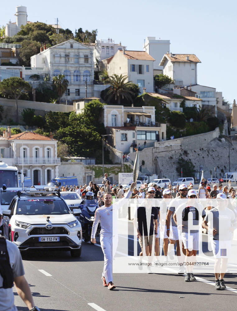 Paris Olympic torch relay begins A torchbearer runs in Marseille on May 9, 2024, as the Paris Olympic torch relay begins following the arrival of the Olympic flame in the southern French port city on a majestic three-mast ship. About 10,000 torchbearers are to pass through over 400 towns until the games opening ceremony in Paris on July 26. A14AA0002809051P