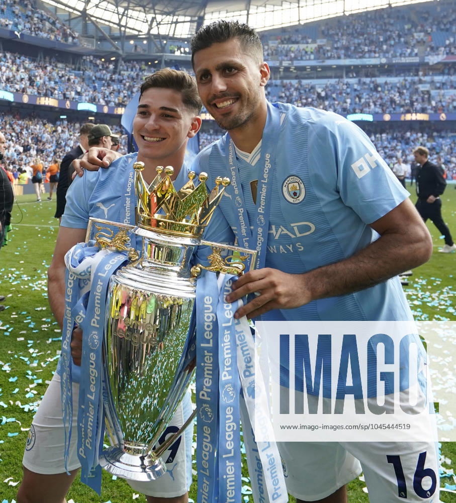 Manchester, England, 19th May 2024. Rodri of Manchester City (R) and Julian Alvarez of Manchester City celebrate with the Premier league trophy during the Premier League match at the Etihad Stadium, Manchester. Picture credit should read: Andrew Yates Sportimage . SPI-3159-0071