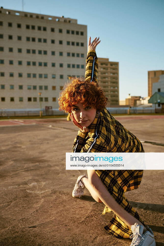 Redhead curly young female dancing in an empty parking lot Valencia, Valencian Community, Spain CR_BVBE200916B-504100-01 ,model released, Symbolfoto