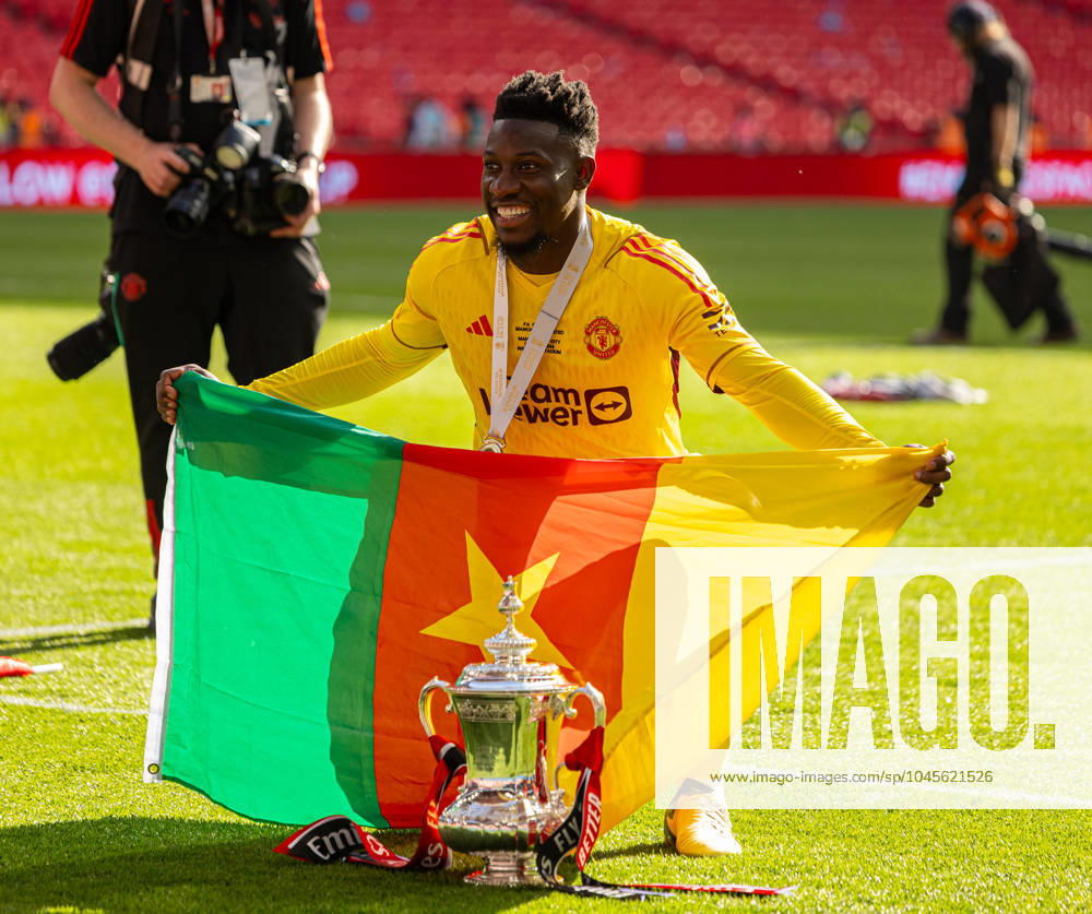 Football - FA Cup - Final - Manchester City FC v Manchester United, ManU FC LONDON, ENGLAND - Saturday, May 25, 2024: Manchester United s goalkeeper Andrà Onana celebrates with the trophy and the Cameroon flag after the FA Cup Final between Manchester City FC and Manchester United FC at Wembley Stadium. Man Utd won 2-1. (Photo by David Rawcliffe Propaganda) LONDON Wembley Stadium GREATER LONDON ENGLAND