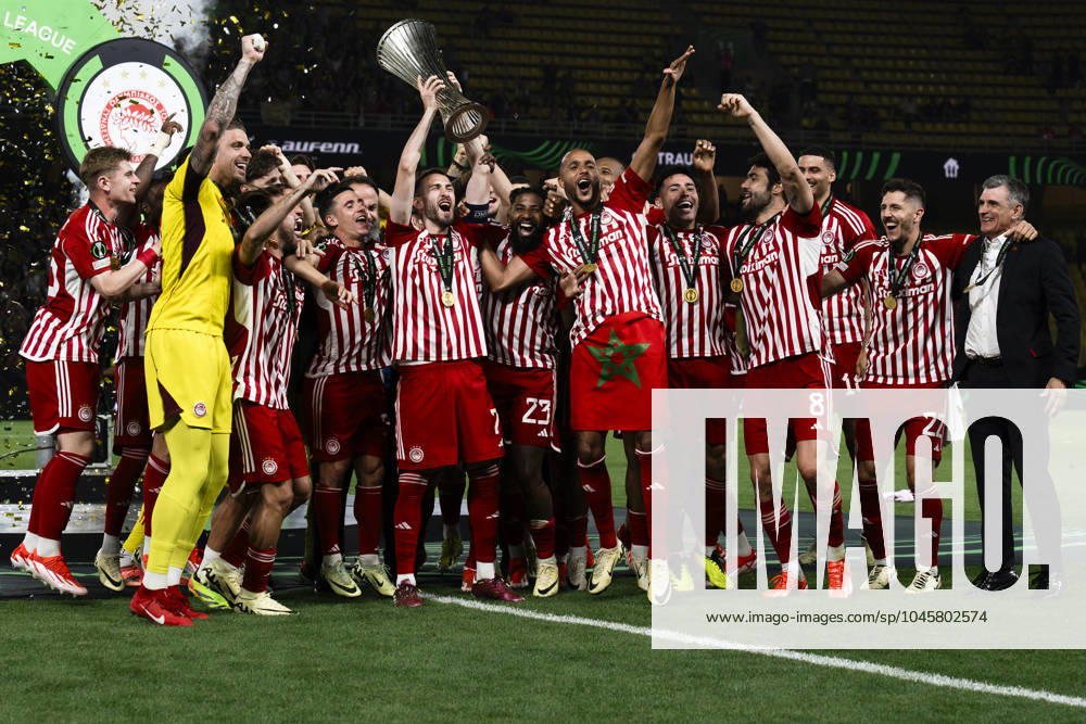 Olympiacos FC v ACF Fiorentina - UEFA Conference League Kostas Fortounis of Olympiaocs FC lifts the trophy as teammates celebrate during the award ceremony following the UEFA Conference League final football match between Olympiacos FC and ACF Fiorentina. Athens Greece