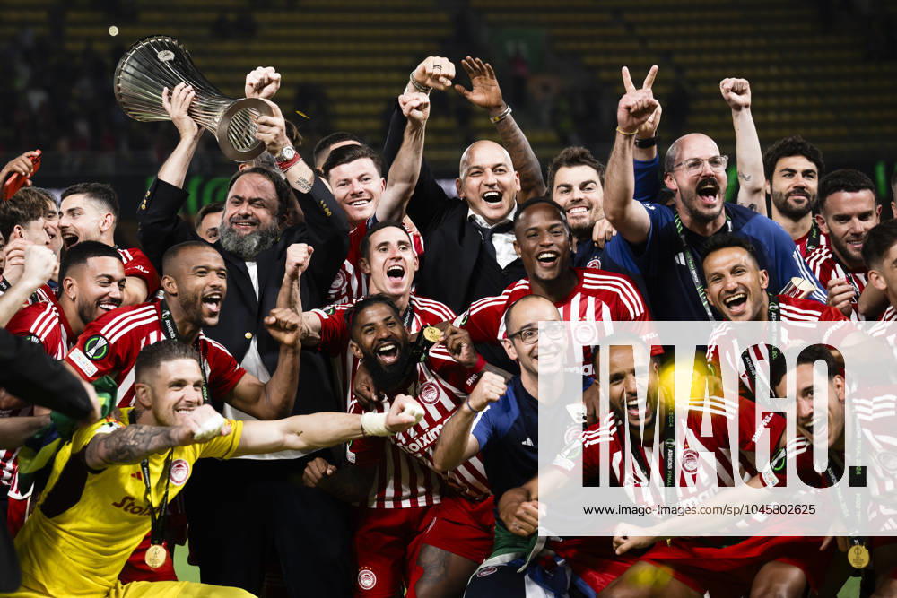 Olympiacos FC v ACF Fiorentina - UEFA Conference League Evangelos Marinakis lifts the trophy as players of Olympiacos FC celebrate during the award ceremony following the UEFA Conference League final football match between Olympiacos FC and ACF Fiorentina. Athens Greece