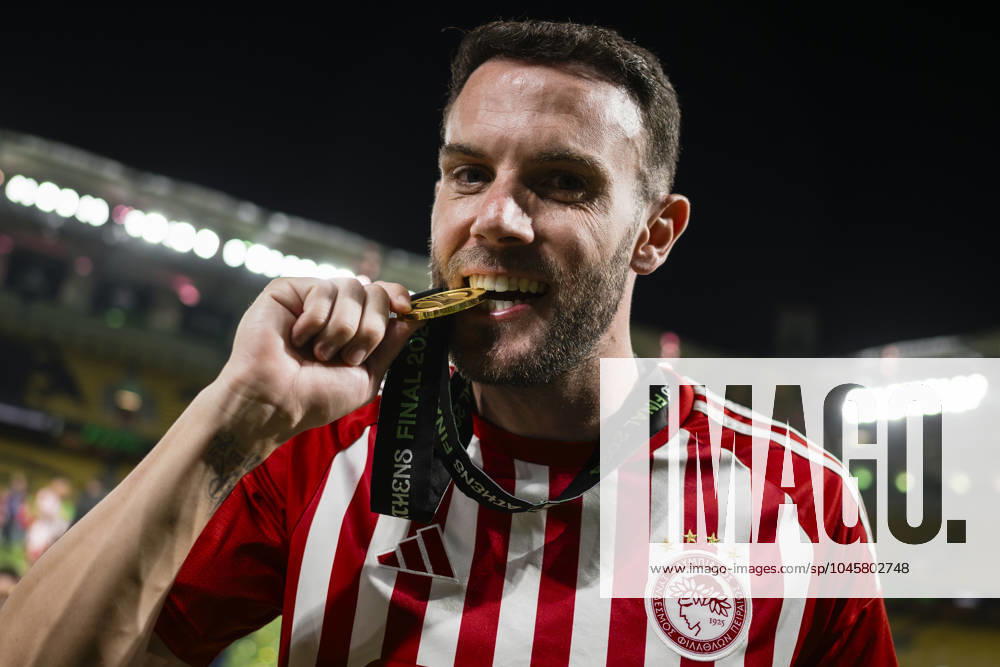 Olympiacos FC v ACF Fiorentina - UEFA Conference League Quini of Olympiacos FC bites his medal during the award ceremony following the UEFA Conference League final football match between Olympiacos FC and ACF Fiorentina. Athens Greece