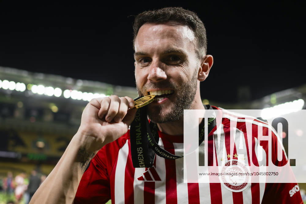 Olympiacos FC v ACF Fiorentina - UEFA Conference League Quini of Olympiacos FC bites his medal during the award ceremony following the UEFA Conference League final football match between Olympiacos FC and ACF Fiorentina. Athens Greece