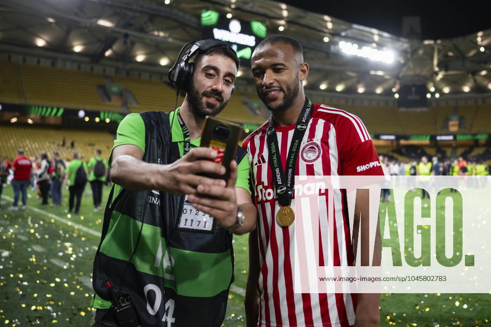 Olympiacos FC v ACF Fiorentina - UEFA Conference League A worfer takes a photo with Ayoub El Kaabi of Olympiacos FC during the award ceremony following the UEFA Conference League final football match between Olympiacos FC and ACF Fiorentina. Athens Greece