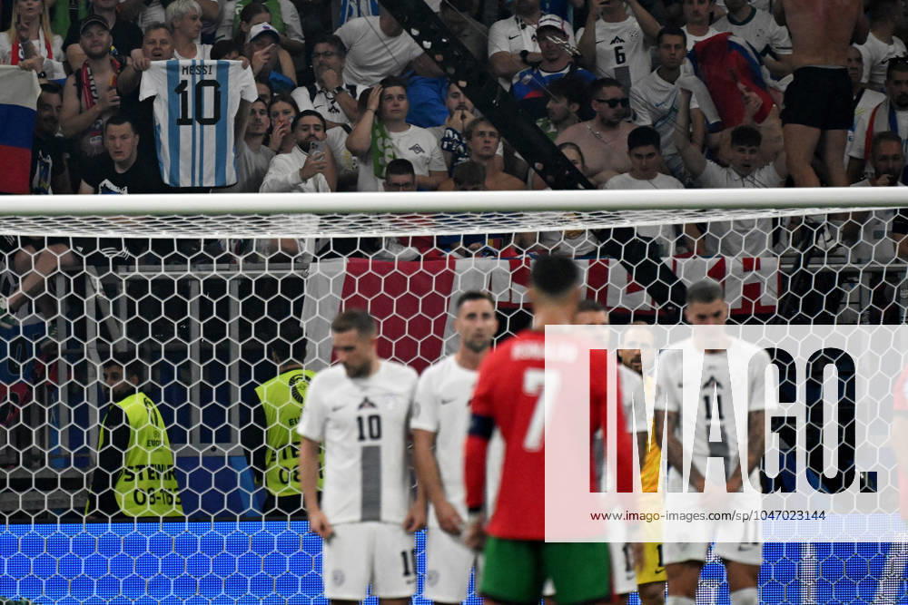 Football EM 2024 1 8 Final, Portugal Slovenia, v l Slovenian fan shows the jersey of Lionel Messi Kurios Cristiano Ronaldo Portugal UEFA REGULATIONS PROHIBIT ANY USE OF PHOTOGRAPHS as IMAGE SEQUENCES and or QUASI VIDEO Frankfurt am Main