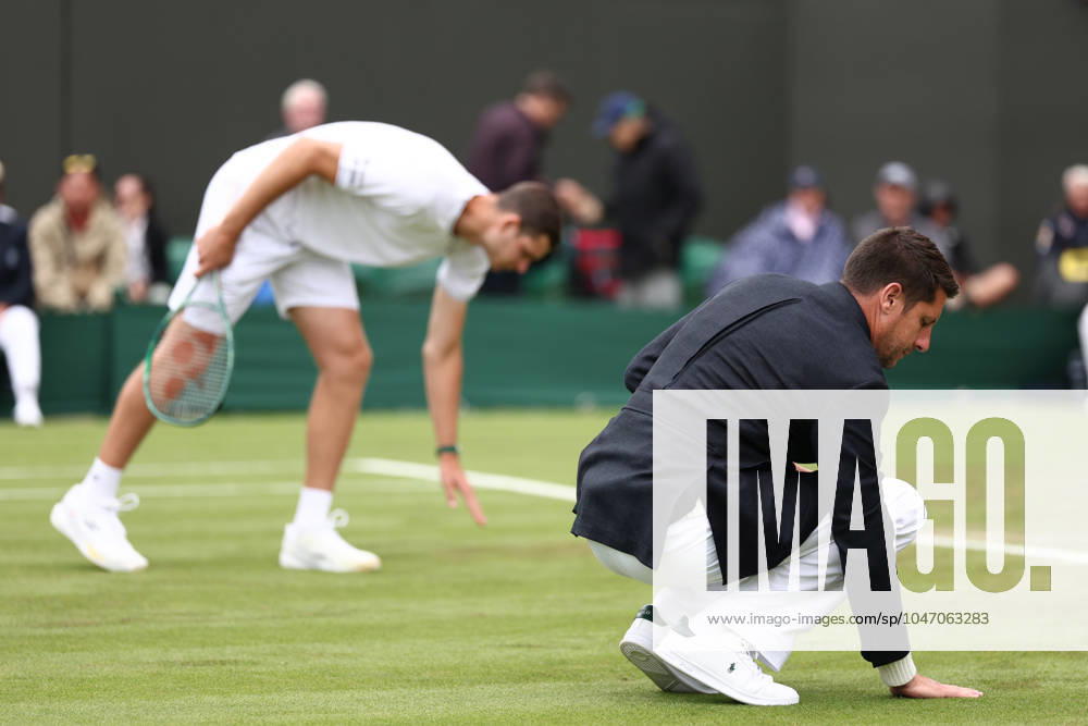 2nd July 2024; All England Lawn Tennis and Croquet Club, London, England; Wimbledon Tennis Tournament, Day 2; The referee checks how wet the court is ActionPlus12663083 ShaunxBrooks
