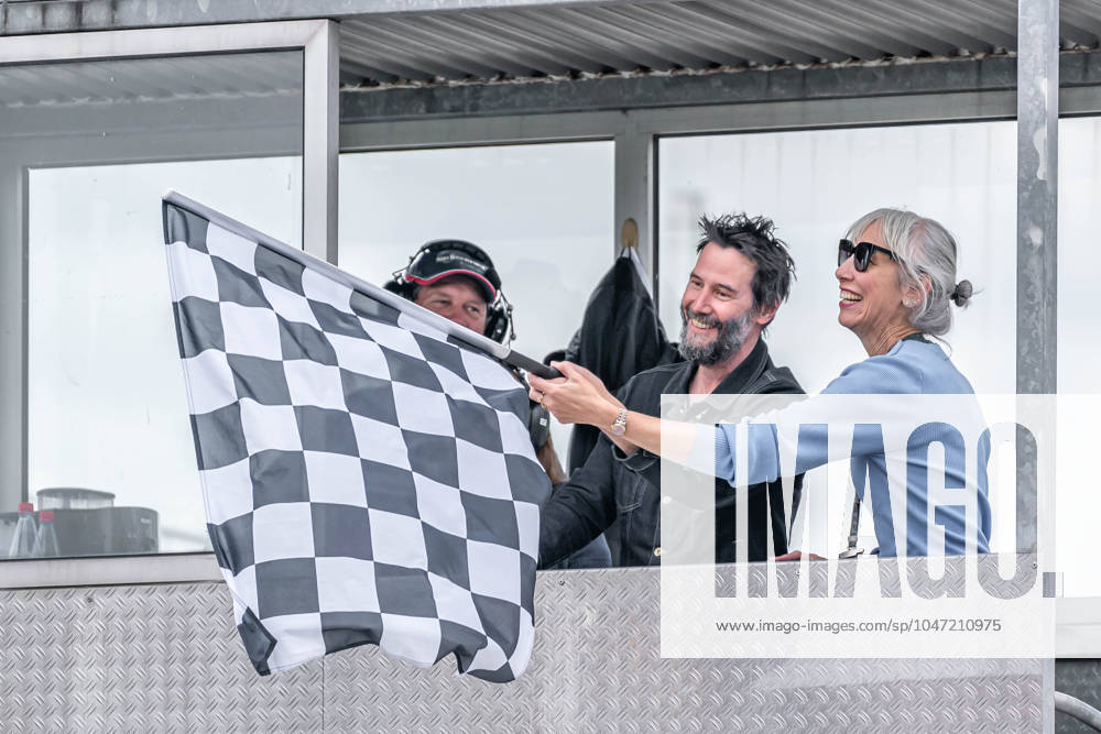 Hohenstein, Germany 05 07 July 2024 MotoGP Sachsenring Germany 2024 Pictured Keanu Reeves waving the chequered flag with his wife