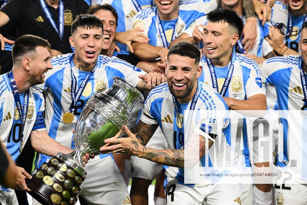 Copa America USA 2024 Argentina vs Colombia - Final Lionel Messi, Enzo Martinez, Nicolas Otamendi lifts up the trophy as he celebrates winning the Conmebol 2024 Copa America during Final match between Argentina and Colombia as part of CONMEBOL Copa America USA 2024 at Hard Rock Stadium on July 14, 2024 in Miami Gardens, Florida, United States. MIAMI GARDENS FLORIDA UNITED STATES