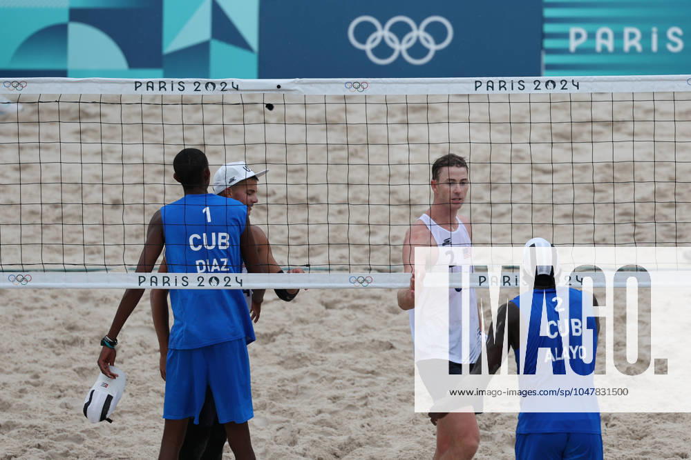 (240727) -- PARIS, July 27, 2024 -- Noslen Diaz Amaro Jorge Luis Alayo Moliner of Cuba and Miles Partain Andrew Benesh of the United States greet each other after the men s pool D Beach volleyball, Beachvolleyball match between the United States and Cuba at the Paris 2024 Olympic Games, Olympische Spiele, Olympia, OS in Paris, France, on July 27, 2024. Huang Zongzhi) (PARIS2024)FRANCE-PARIS-BEACH VOLLEYBALL-MEN S PRELIMINARY huangzongzhi