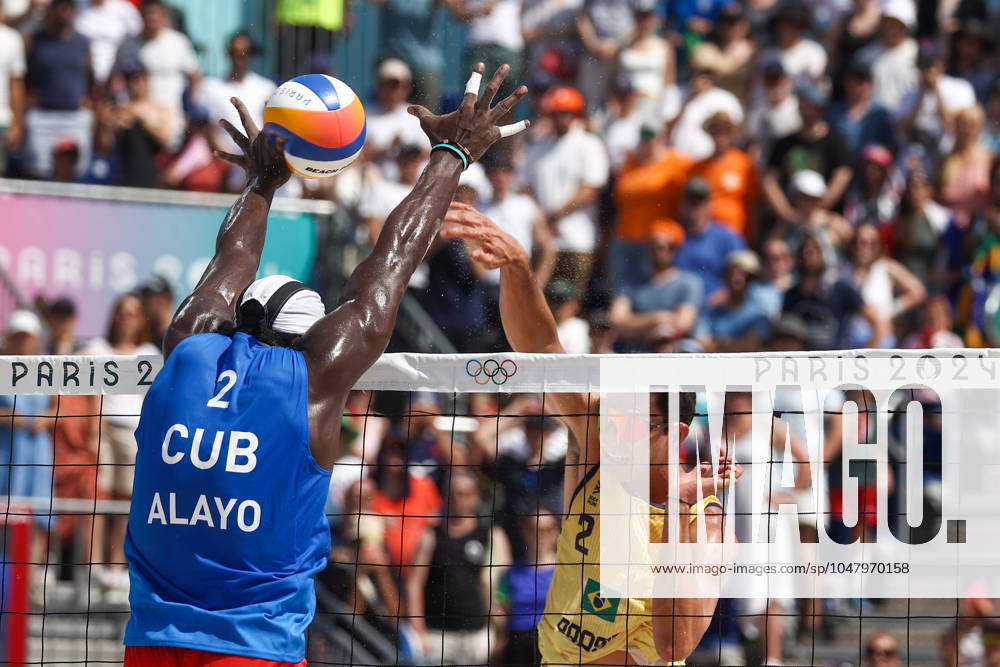 FRANCE, PARIS - JULY 30, 2024: Jorge Luis Alayo Moliner of Cuba (L) and Andre Loyola Stein of Brazil compete in a men s Pool D - Preliminary Phase Beach volleyball, Beachvolleyball match at the 2024 Summer Olympic Games, Olympische Spiele, Olympia, OS by the Eiffel Tower on the Champ de Mars. 72536641