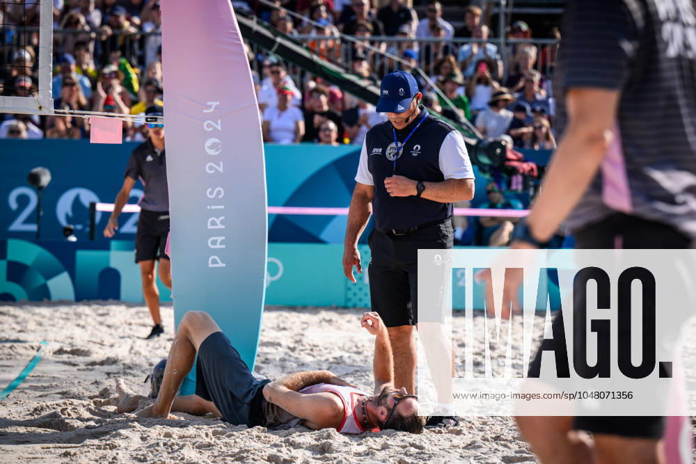 Paris, Eiffel Tower Stadium Beach volleyball, Olympic Games, preliminary round Clemens Wickler GER trips over net camera and injures referee Giovanni Bake RSA with him