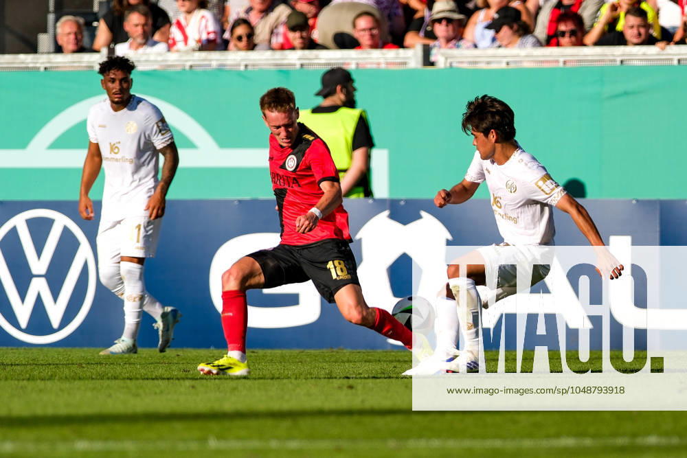 Fabian Greilinger SV Wehen Wiesbaden, 18 in duel with Kaishu Sano 1 FSV Mainz 05, 06 , GER, SV Wehen Wiesbaden vs 1 FSV Mainz 05, Football, DFB Pokal, 1 Round, Season 2024 2025 DFB REGULATIONS PROHIBIT ANY USE OF PHOTOGRAPHS as IMAGE SEQUENCES and or QUASI VIDEO GER, SV Wehen Wiesbaden vs 1 FSV Mainz 05, Football, DFB Pokal, 1 Round, Season 2024 2025 Wiesbaden