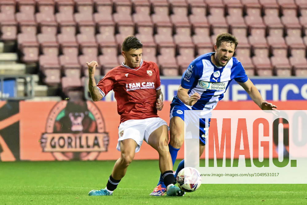 Bristol Street Motors Trophy Wigan Athletic v Morecambe Adam Lewis of Morecambe fouls James Carragher of Wigan Athletic for a penalty during the Bristol Street Motors Trophy match Wigan Athletic vs Morecambe at DW Stadium, Wigan, United Kingdom, 3rd September 2024 (Photo by Cody Froggatt News Images) Wigan DW Stadium Greater Manchester United, ManU Kingdom