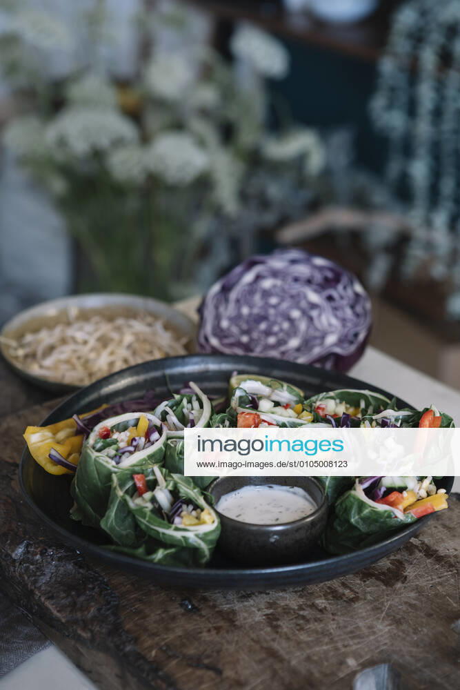 Vegan rolls with vegetables and yoghurt sauce in bowl ALBF01371