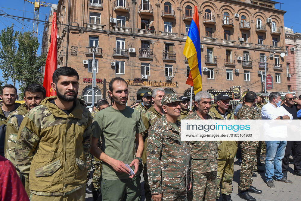 Servicemen and members of the Armenian Revolutionary Federation (ARF) gather by a statue of Aram Manukyan among volunteers who are to set off for Nagorno-Karabakh as tensions rise between Armenia and Azerbaijan over the disputed region. On September 27, 2020, the Armenian government declared martial law and general mobilization in the country. Melik Baghdasaryan Photolure TASS TS0E89C7