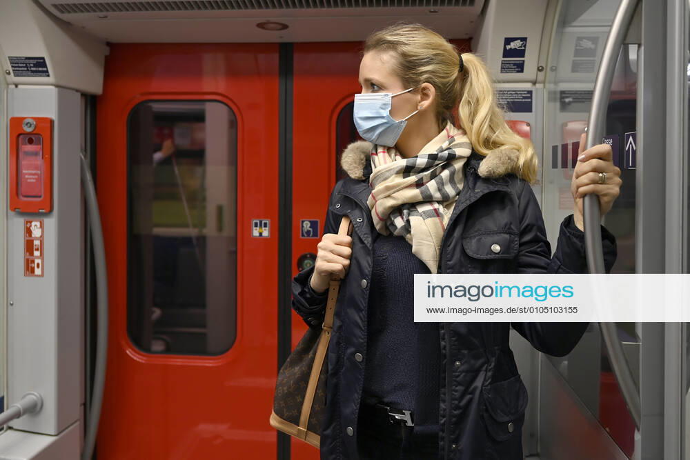 Woman with face mask, standing in S Bahn, Corona crisis, Stuttgart, Baden Württemberg, Germany Coronavirus