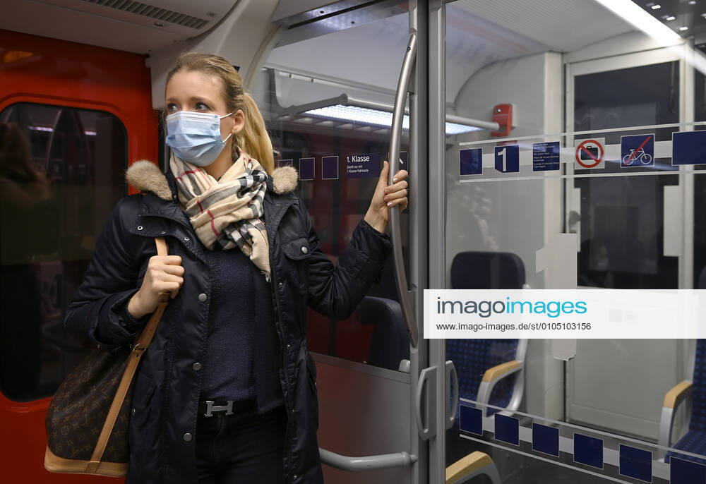Woman with face mask, standing in S Bahn, Corona crisis, Stuttgart, Baden Württemberg, Germany Coronavirus