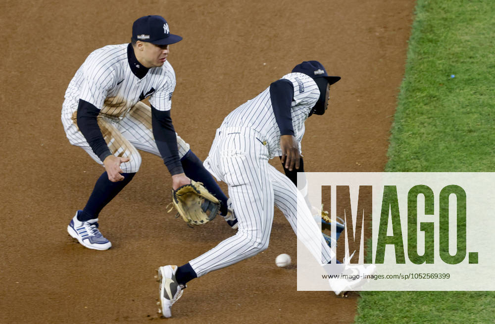 Neither New York Yankees shortstop Anthony Volpe (L) nor third baseman Jazz Chisholm Jr. can field an infield single by Cleveland Guardians Lane Thomas during the fourth inning of ALCS Game 2 at Yankee Stadium in New York, on Tuesday, October 15, 2024. NYP20241015316 JOHNxANGELILLO