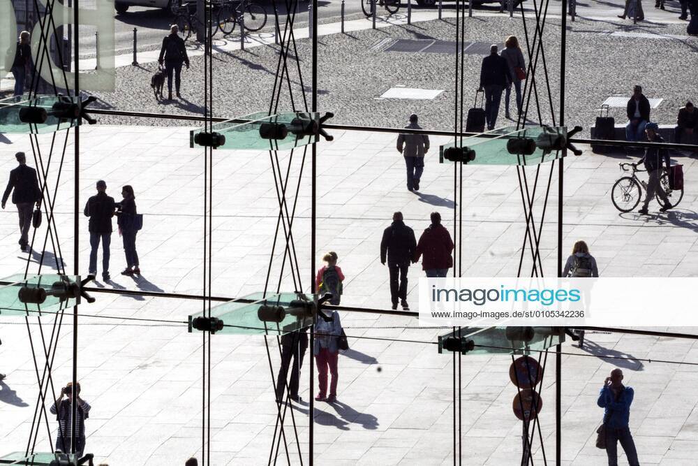 People at the station Silhouettes of people can be seen behind a glass wall at Berlin Central Station on 26 09 2016 Berlin Berlin Germany