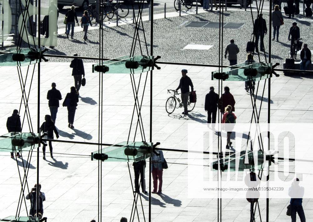 People at the station Silhouettes of people can be seen behind a glass wall at Berlin Central Station on 26 09 2016 Berlin Berlin Germany