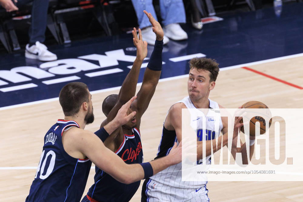 Franz Wagner 22 of the Orlando Magic keeps the ball out of reach of Ivica Zubac 40 and Kris Dunn 8 of the Los Angeles Clippers during their regular season NBA, Basketball Herren, USA game on Wednesday November 20, 2024 at Intuit Dome in Inglewood, California. Clippers defeat Magic, 104-93. ARIANA RUIZ PI Inglewood U.S - ZUMAp124 20241120_zaa_p124_051