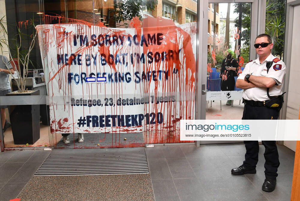 SCOTT MORRISON UQ VACCINE LABS VISIT, A secutity guard is seen guarding a door that has been smeared in fake blood and tomatoes by refugee protestors at the University of Queensland Vaccine Lab during a visit by Prime Minister Scott Morrison in Brisbane, Monday, October 12, 2020. Prime Minister Morrison was touring the University of Queensland s Vaccine Lab to look over their research as they try to develop a vaccine for the coronavirus (COVID-19) ( NO ARCHIVING, , NO USE IN BOOKS WITHOUT CONSENT BRISBANE QLD AUSTRALIA