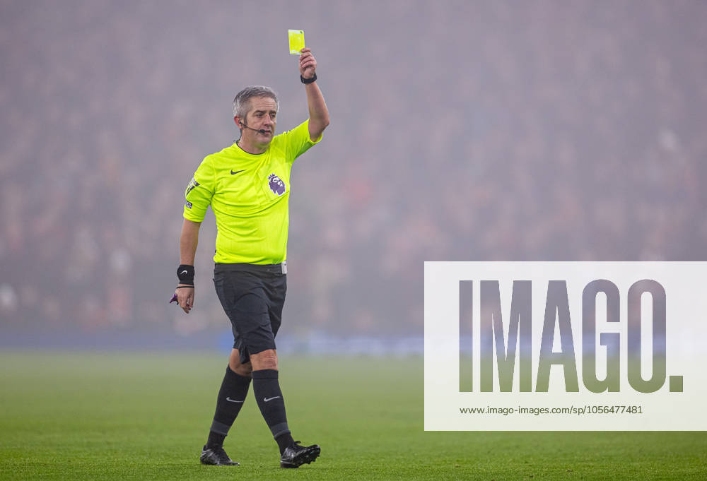 Football - FA Premier League - Liverpool FC v Fulham FC LIVERPOOL, ENGLAND - Saturday, December 14, 2024: Referee Darren Bond shows a yellow card during the FA Premier League match between Liverpool FC and Fulham FC at Anfield. (Photo by David Rawcliffe Propaganda) LIVERPOOL Anfield MERSEYSIDE ENGLAND