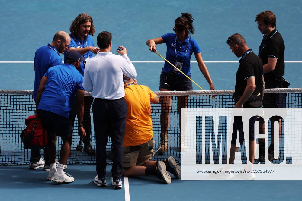 A handyman fixes the broken net during the fourth round match between Rune and Sinner Australian Open, Day Nine, Tennis, Melbourne Park, Melbourne, Australia - 20 Jan 2025