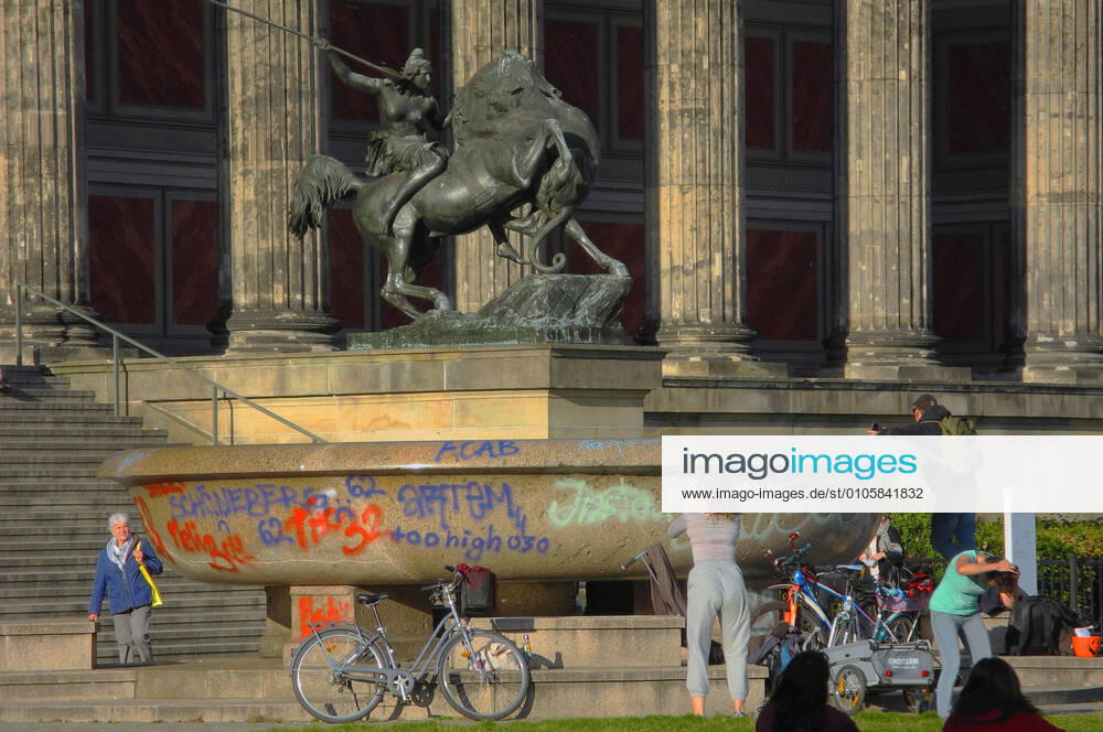 The granite bowl in front of the Altes Museum is damaged with graffiti graffiti